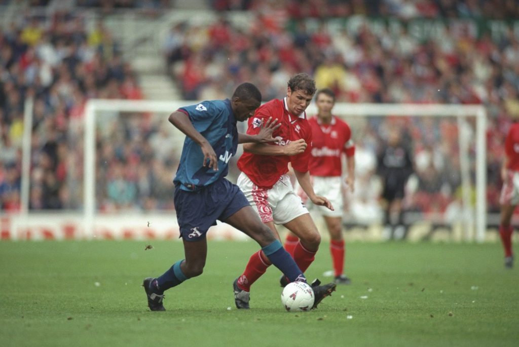 Patrick Vieira of Arsenal, on the ball, holds off Neil Cox of Middlesbrough